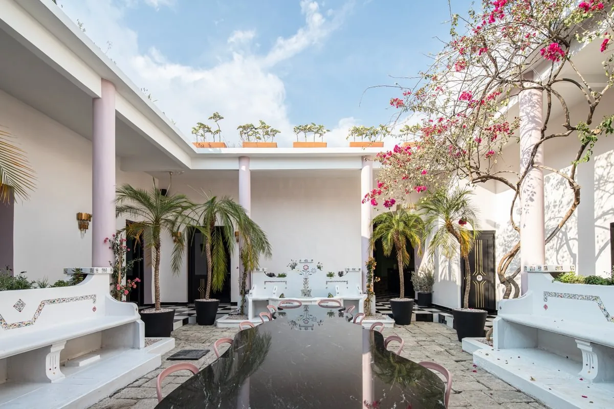 Courtyard with a black reflecting pool, palms and bougainvillea at Hotel De Mi Independencia, Oaxaca